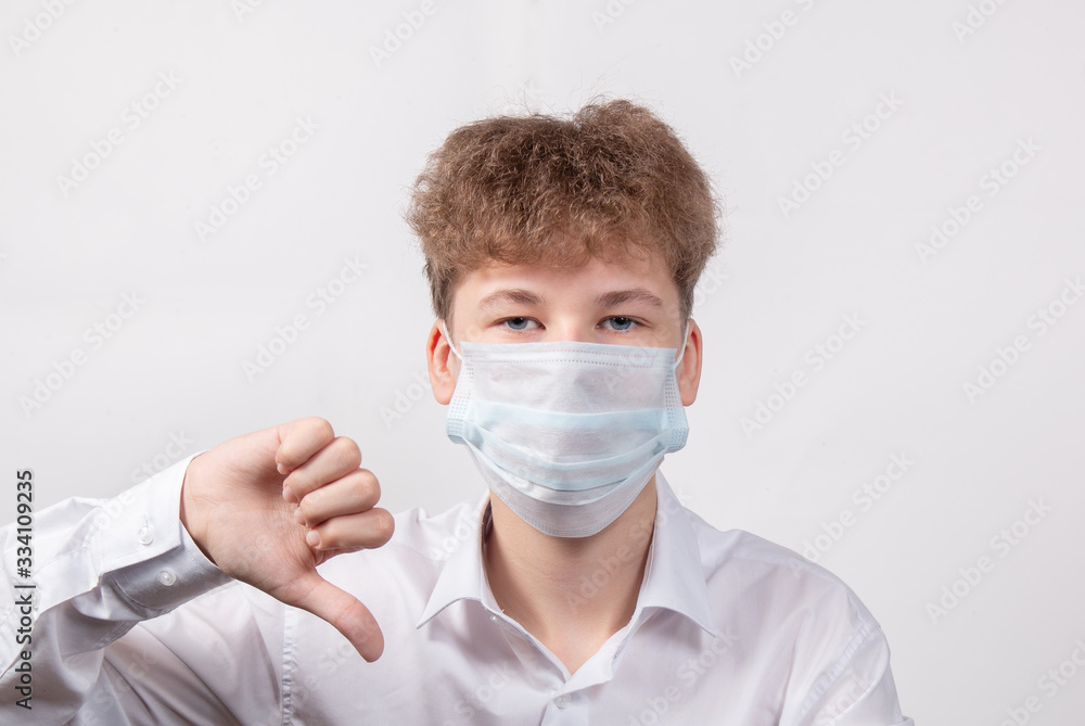 Teenage boy in protective medical mask on a white background