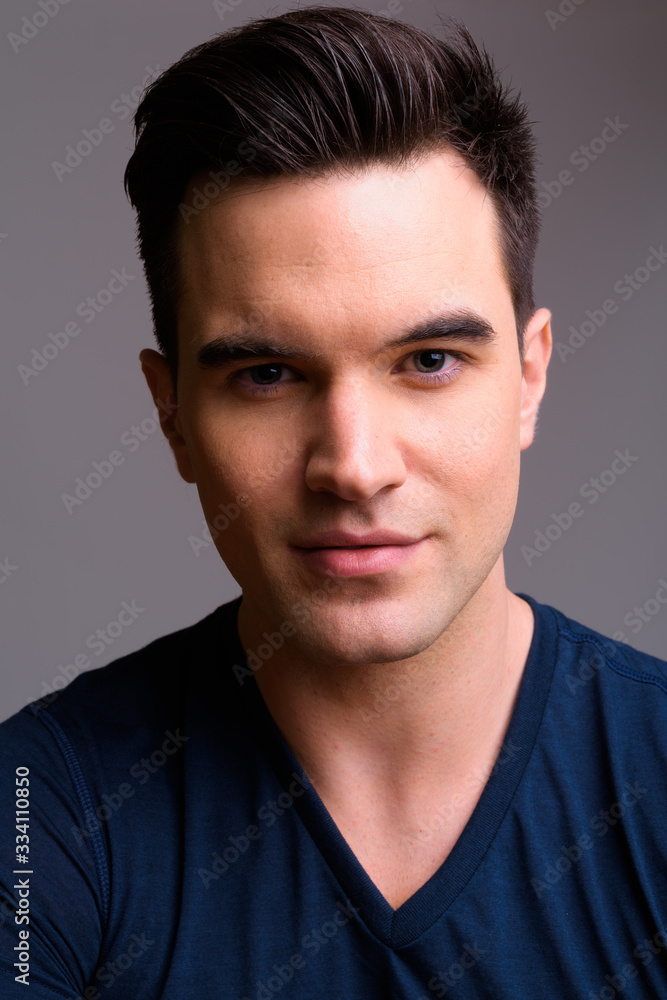 Fototapeta premium Face of young handsome man looking at camera