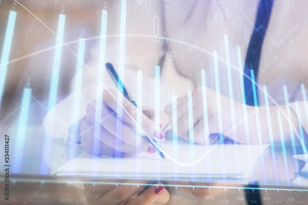 Double exposure of hands making notes with forex chart huds. Stock market concept. Double exposure of hands making notes with forex chart huds. Stock market concept.