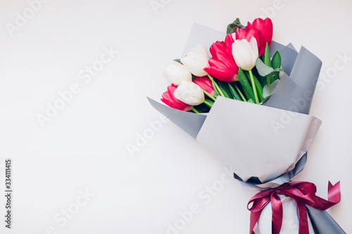 Fototapeta Naklejka Na Ścianę i Meble -  Present gift for Mother's day. Spring flowers for International Women's day. Bouquet of white and pink tulips.