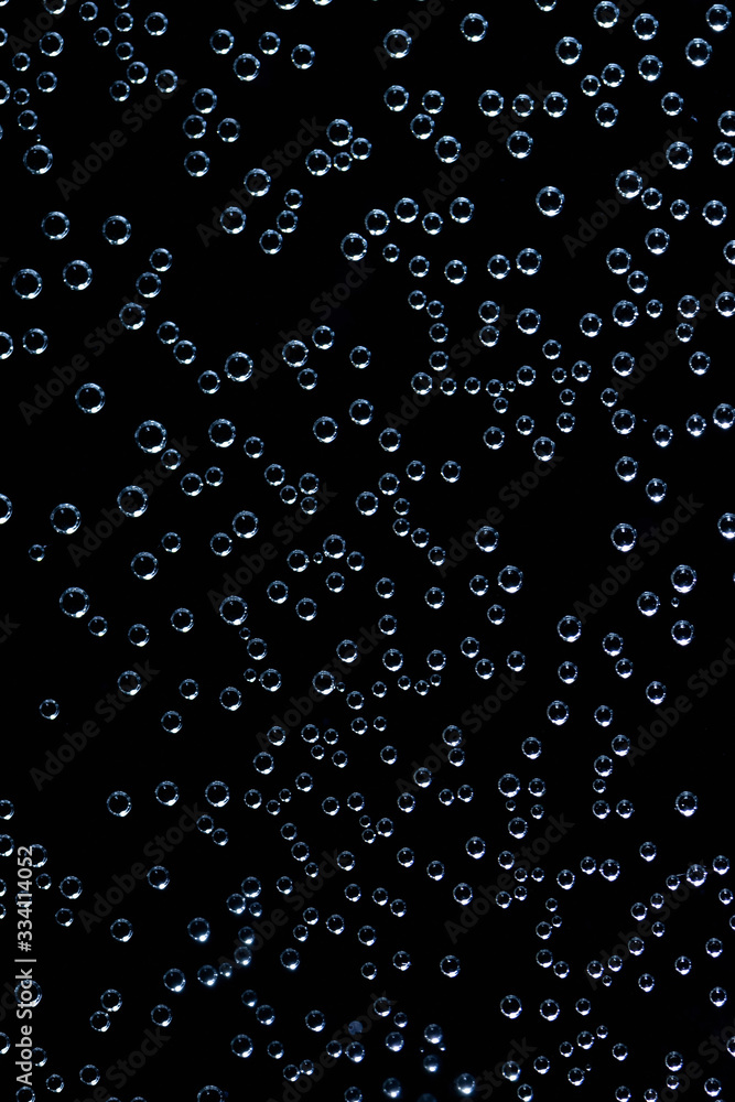 Air bubbles in the water on black background.