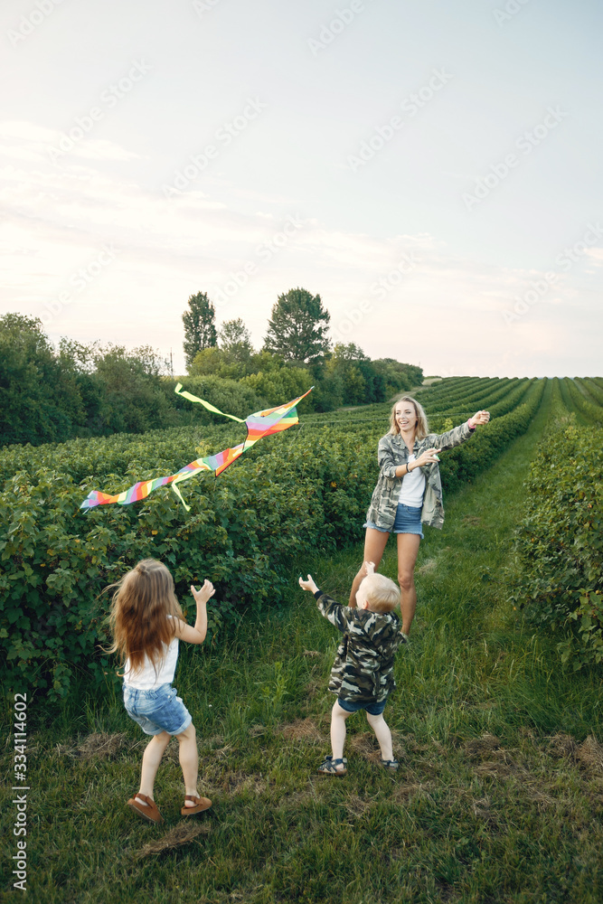 Obraz premium Mother with two children. Family with a Kite. Brother with a little sister