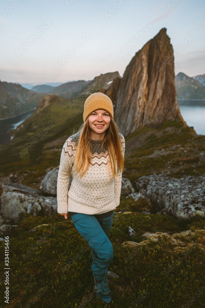 Woman traveling alone in Norway adventure scandinavian vacations healthy lifestyle outdoor sustainable  tourism solo trip Segla mountain landscape