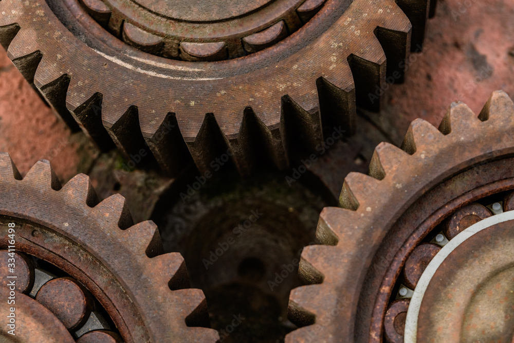 Three meshing gears on the machine. Old rusty industrial mechanism. background Three meshing gears on the machine. Old rusty industrial mechanism. background