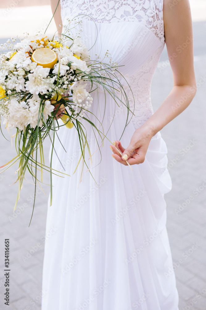 bride in white dress with bouquet of flowers