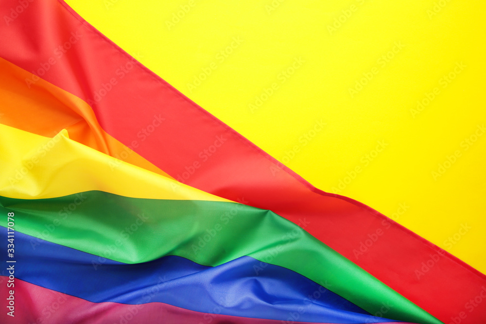 Rainbow LGBT flag on yellow background with copy space Rainbow LGBT flag on yellow background with copy space