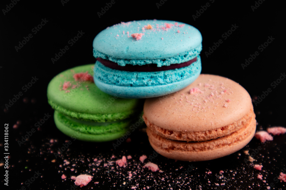 Fototapeta premium Macaroons on a black background. Sweet pastries.