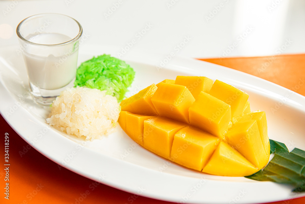 Sticky rice with fresh ripe mango and coconut milk, popular traditional Thai dessert Sticky rice with fresh ripe mango and coconut milk, popular traditional Thai dessert