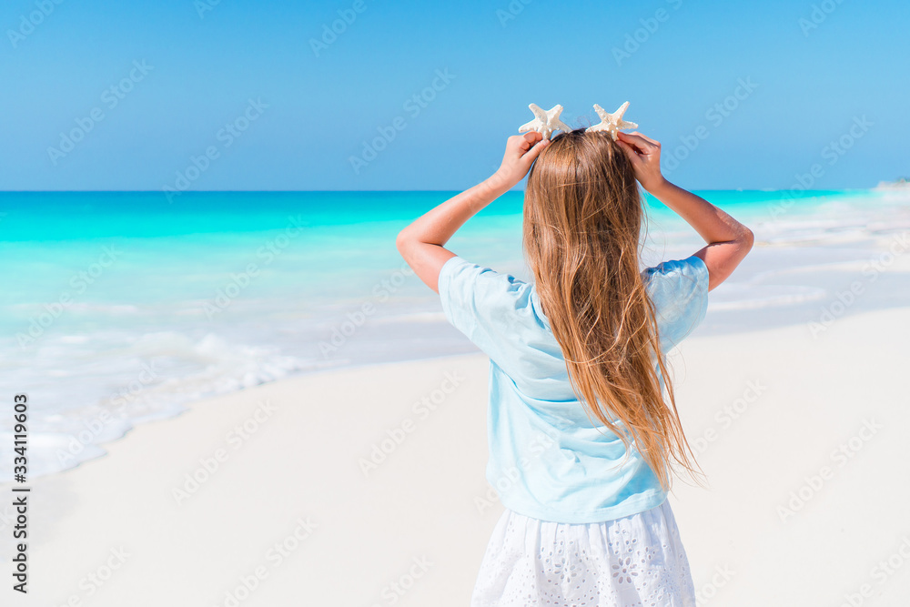 Adorable little girl have fun at tropical beach during vacation Adorable little girl have fun at tropical beach during vacation
