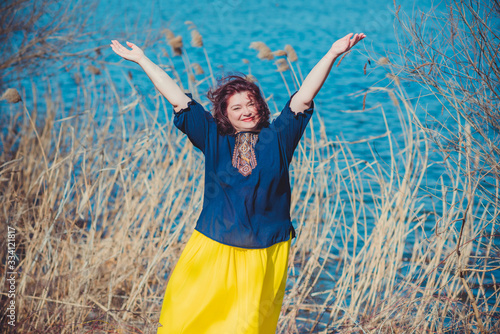 Woman hands up high to sun, slavic culture and magic 