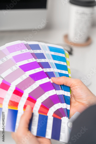 Graphic designer works on the choice of palette colors for creative business