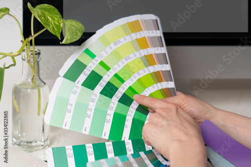 Graphic designer works on the choice of palette colors for creative business