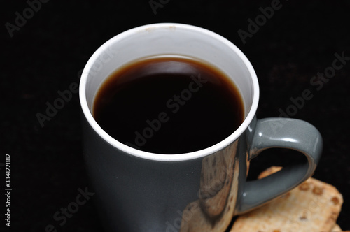 A gray mug filled with black coffee