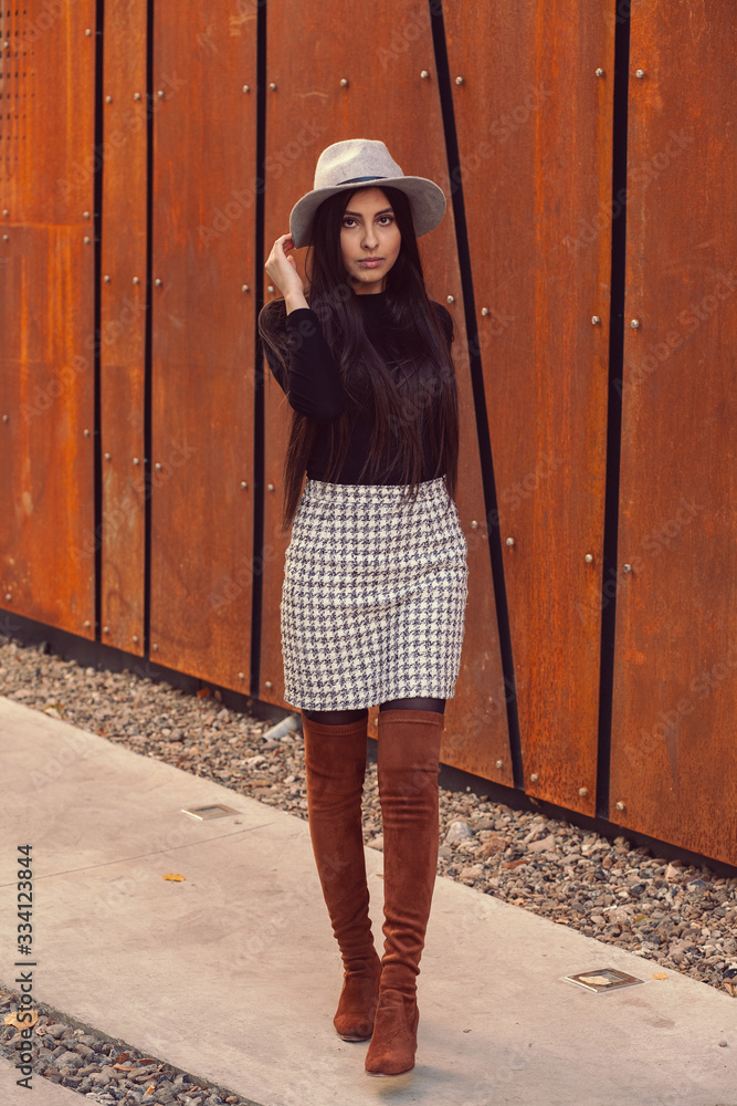 Beautiful girl model posing against the background of the modern building
