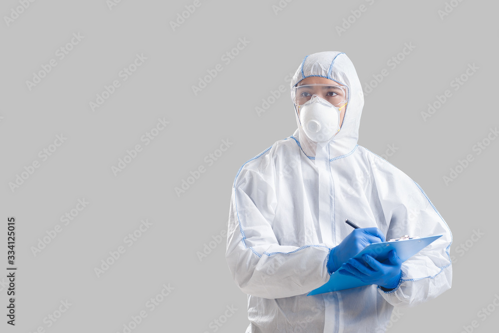 Asian man in a protective suit writes data about coronavirus Asian man in a protective suit writes data about coronavirus