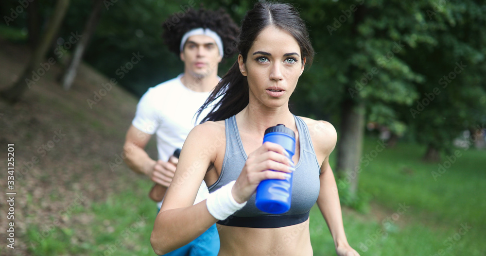 Fototapeta premium Beautiful couple jogging in nature living healthy