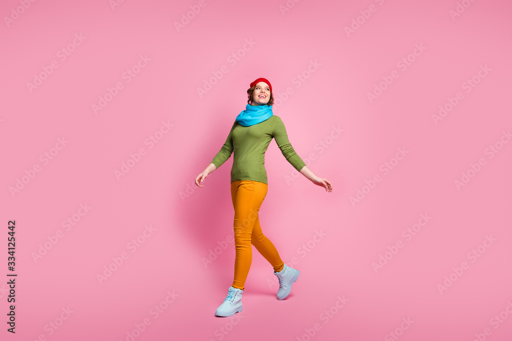 Full body photo of cheerful satisfied girl go walk enjoy winter season holidays wear modern shoes jumper isolated over pastel color background