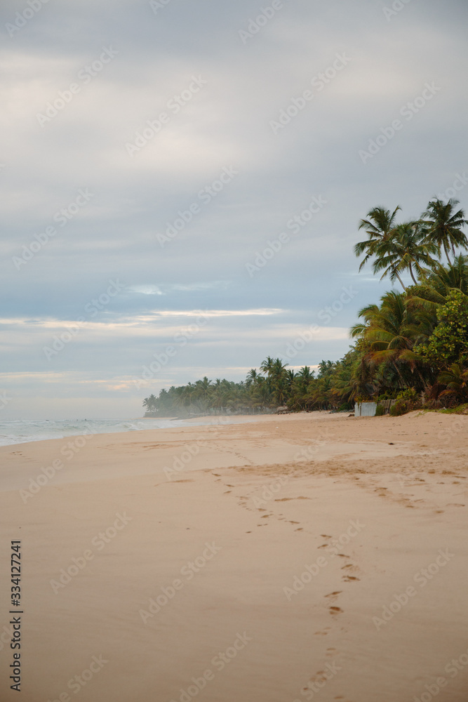 The coast of the Indian Ocean at dawn in Sri Lanka in March 2020. Calm beautiful water and azure blue waves The coast of the Indian Ocean at dawn in Sri Lanka in March 2020. Calm beautiful water and azure blue waves