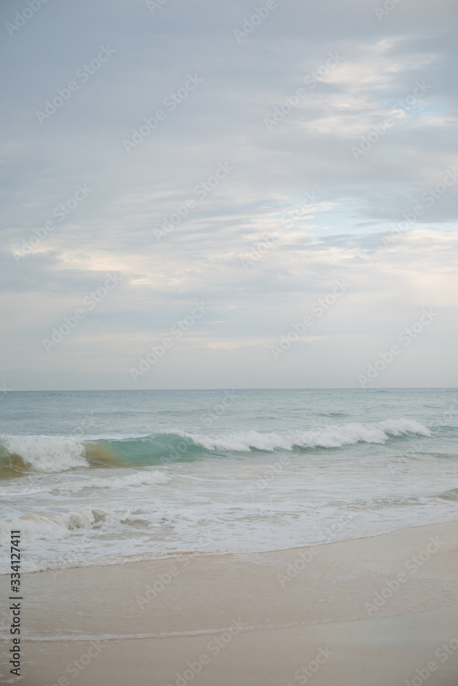 The coast of the Indian Ocean at dawn in Sri Lanka in March 2020. Calm beautiful water and azure blue waves