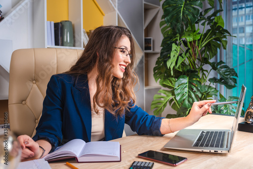 Business woman working, sitting at the table in office