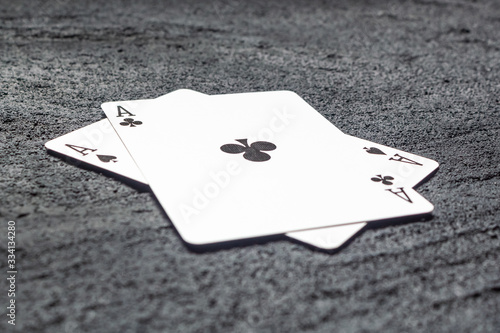 two black aces spades and crosses on black concrete dark background .copy space