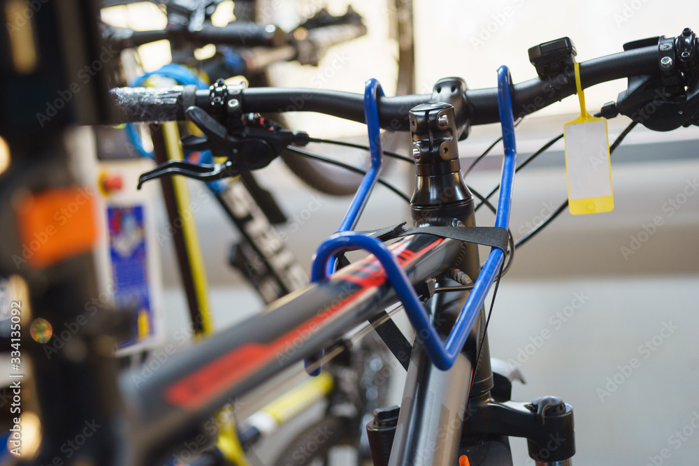 Mechanic or serviceman installing wheel on a bicycle in workshop Mechanic or serviceman installing wheel on a bicycle in workshop