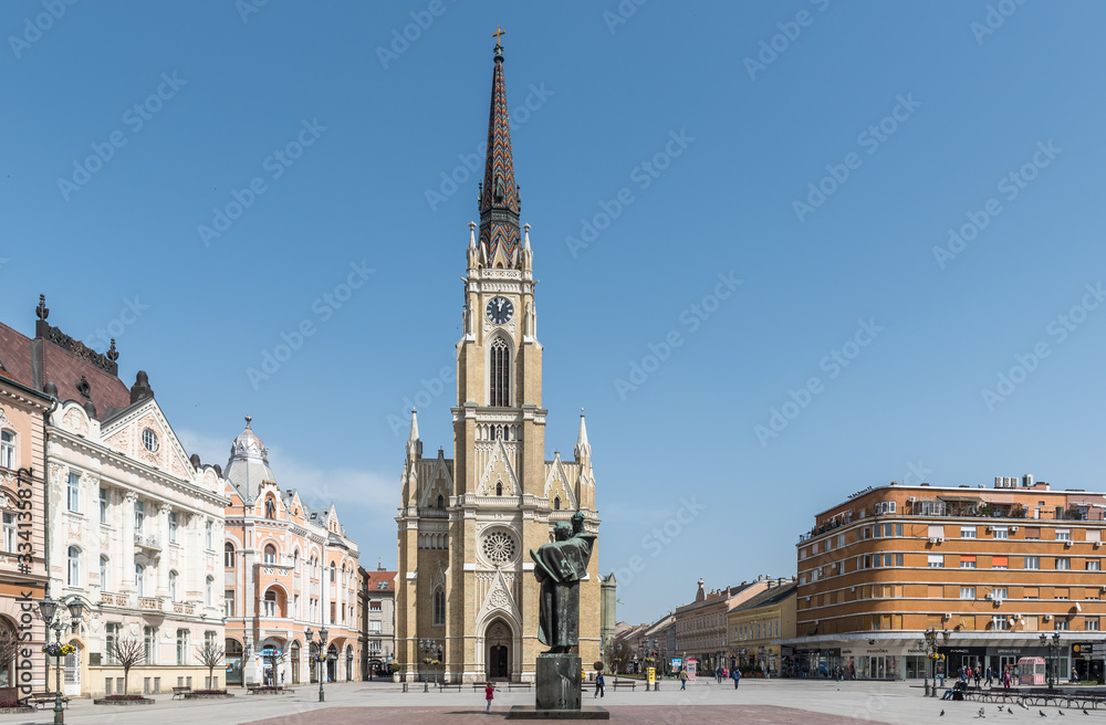 Novi Sad, Serbia city center with cathedral and old buildings with small group of people almost empty during the coronavirus or covid-19 isolation
