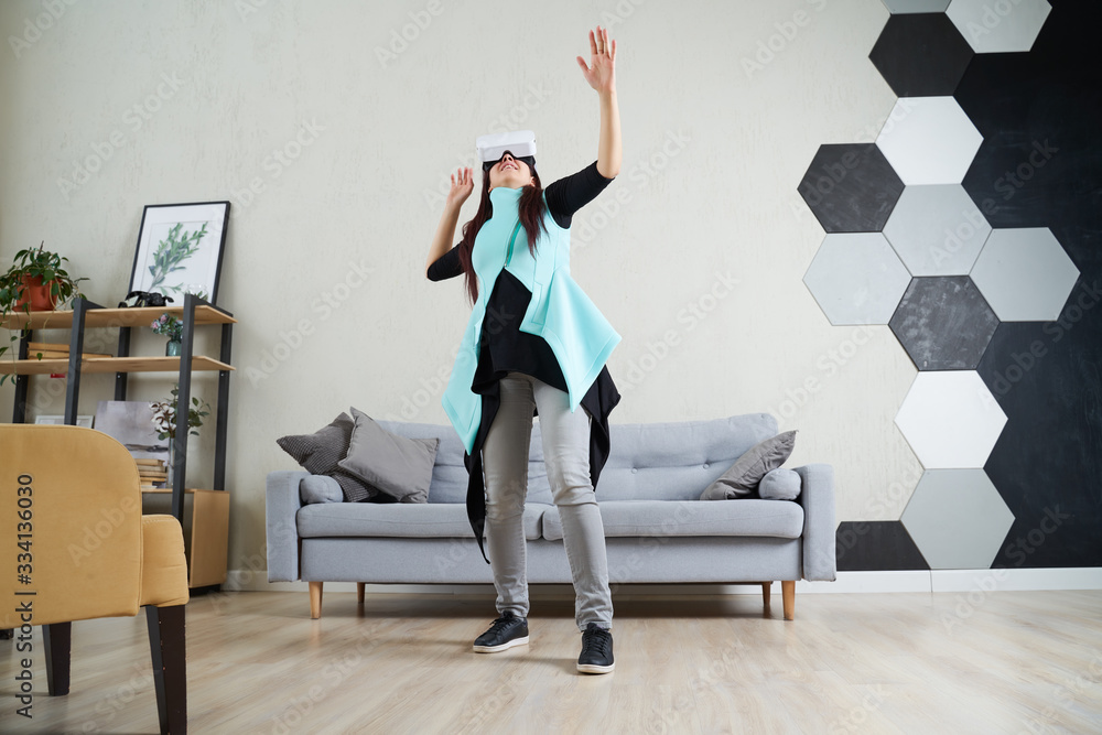 Fototapeta premium Woman with virtual reality headset is playing game.