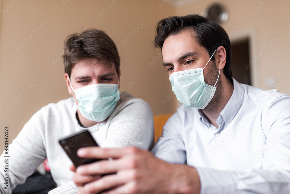 Two businessmen with protective masks working from quarantine