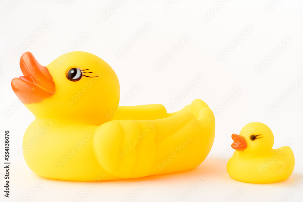 Fototapeta premium Yellow inflatable duck toy with a little duckling. Isolated on a white background.