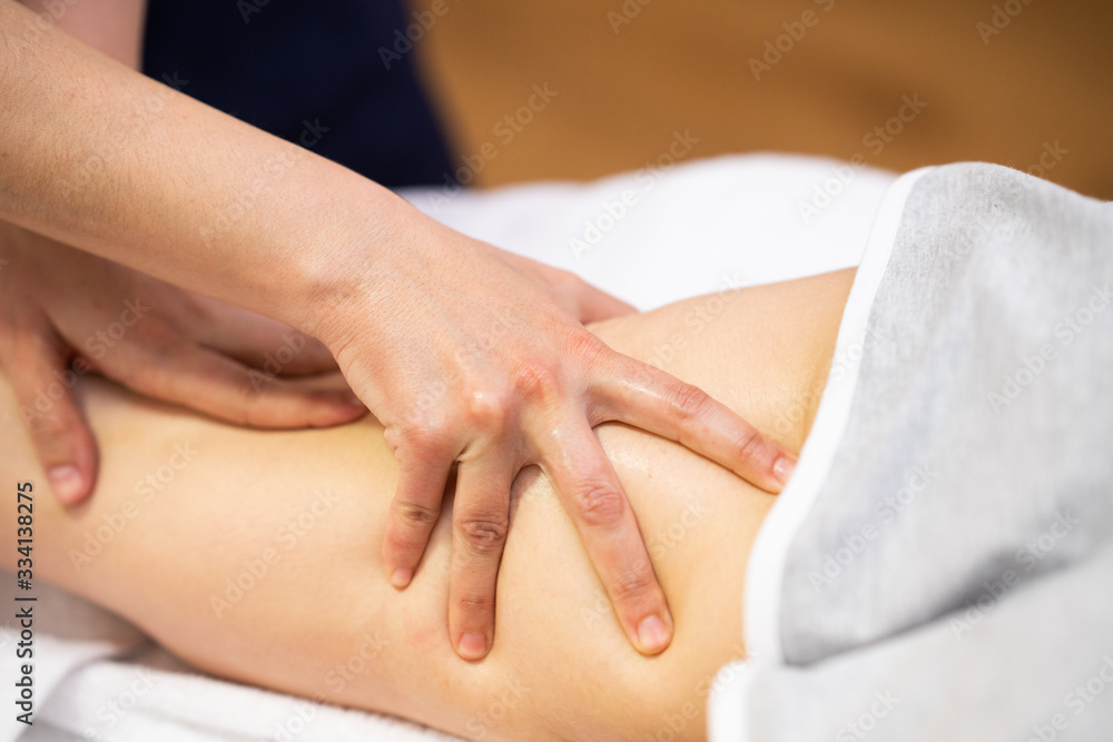 Medical massage at the leg in a physiotherapy center. Medical massage at the leg in a physiotherapy center.
