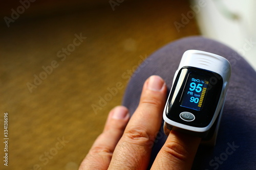 Fototapeta Pulse oximeter measuring oxygen saturation in blood and heart rate