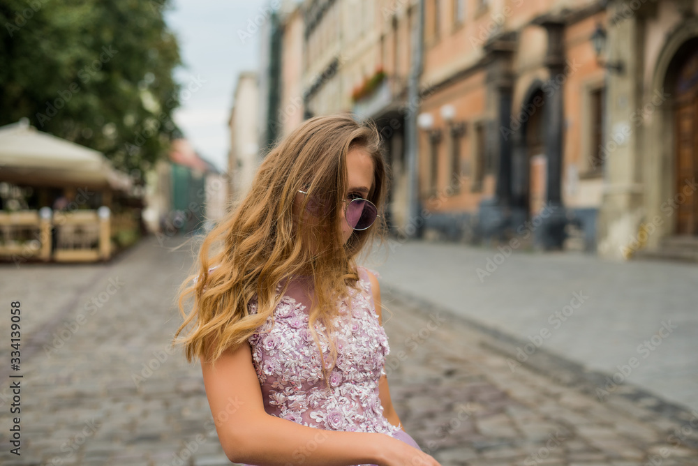 Portrait of young gil wearing dress and violet sunglasses. tattoes over her arms and face. Close up. City walk. Subculture attributes. Portrait of young gil wearing dress and violet sunglasses. tattoes over her arms and face. Close up. City walk. Subculture attributes.