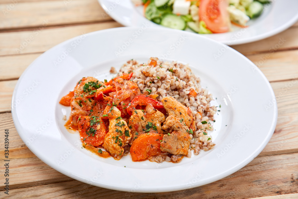 meat with buckwheat and salad on the wooden background meat with buckwheat and salad on the wooden background