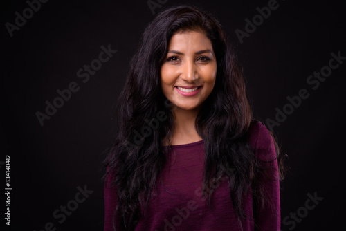 Face of happy young beautiful Indian woman smiling