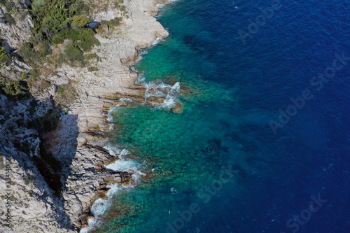 The rocky coast of nice with the sea surf. The landscape of the French Riviera the view from the top. Kitesurfing.