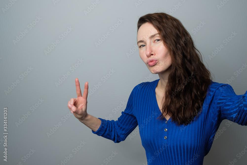 pretty brunette girl in a shirt makes selfie pretty brunette girl in a shirt makes selfie