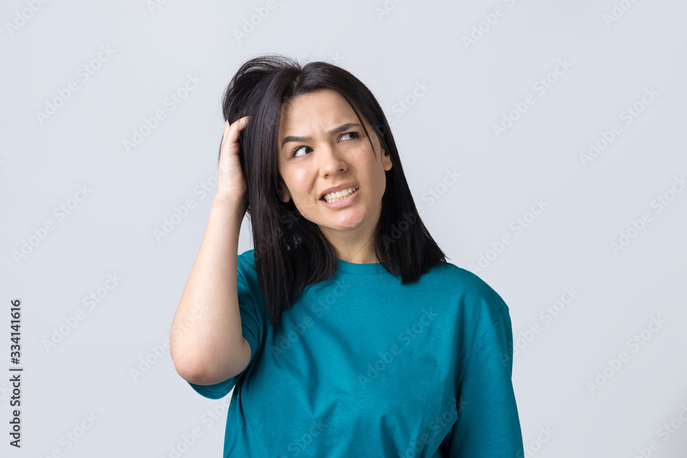 Portrait of a beautiful girl in a blue t-shirt, looks aside with pensive expression, is considering a plan for further action. Portrait of a beautiful girl in a blue t-shirt, looks aside with pensive expression, is considering a plan for further action.