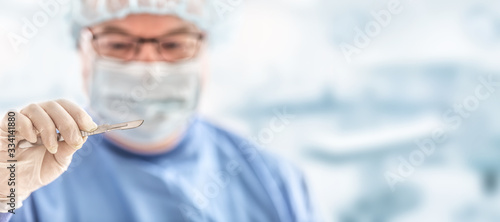 Wallpaper Mural Doctor surgeon specialist with scalpel. In the background blurred the interior of the operating room Torontodigital.ca