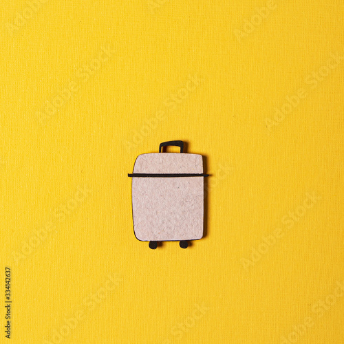 wooden suitcase on the yellow background
