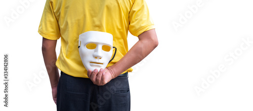Quadro em tela Businessman hide the white mask in the hand behind his back on black background