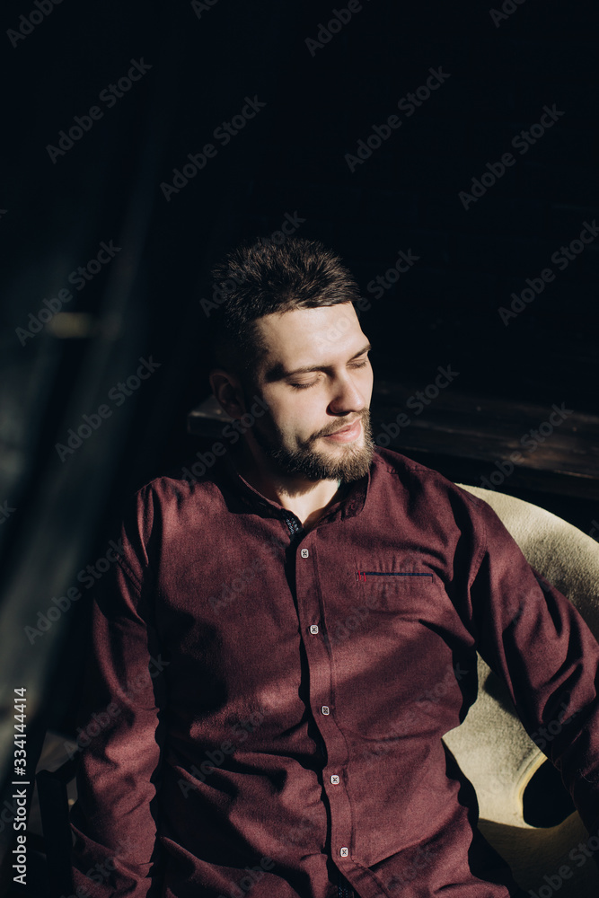  Portrait of young stylish man with closed eyes