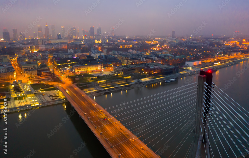 Fototapeta premium Warsaw with Swietokrzyski Bridge at twilight