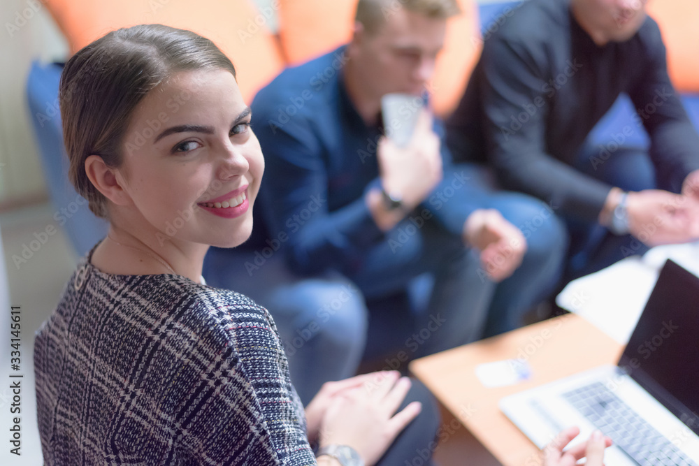 Group of a young business people brainstorming and discussing business plan on meeting at sunny bright office interior. Group of a young business people brainstorming and discussing business plan on meeting at sunny bright office interior.