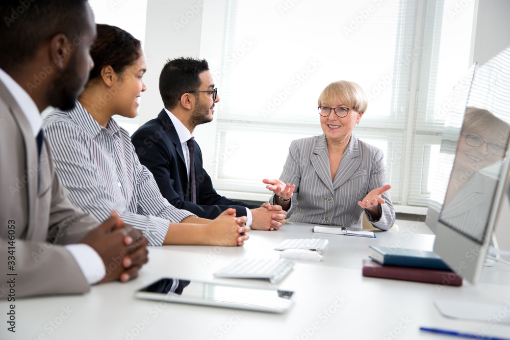 International group of business people working and communicating near office desk together. International group of business people working and communicating near office desk together.