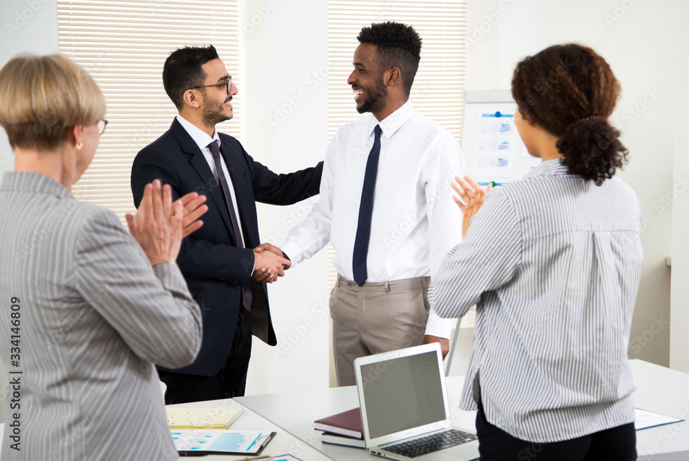 Business people congratulate their colleague of the success on the business seminar. Business people congratulate their colleague of the success on the business seminar.