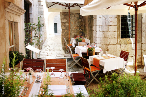 Empty cafe in old european narrow street in summer time vacation
