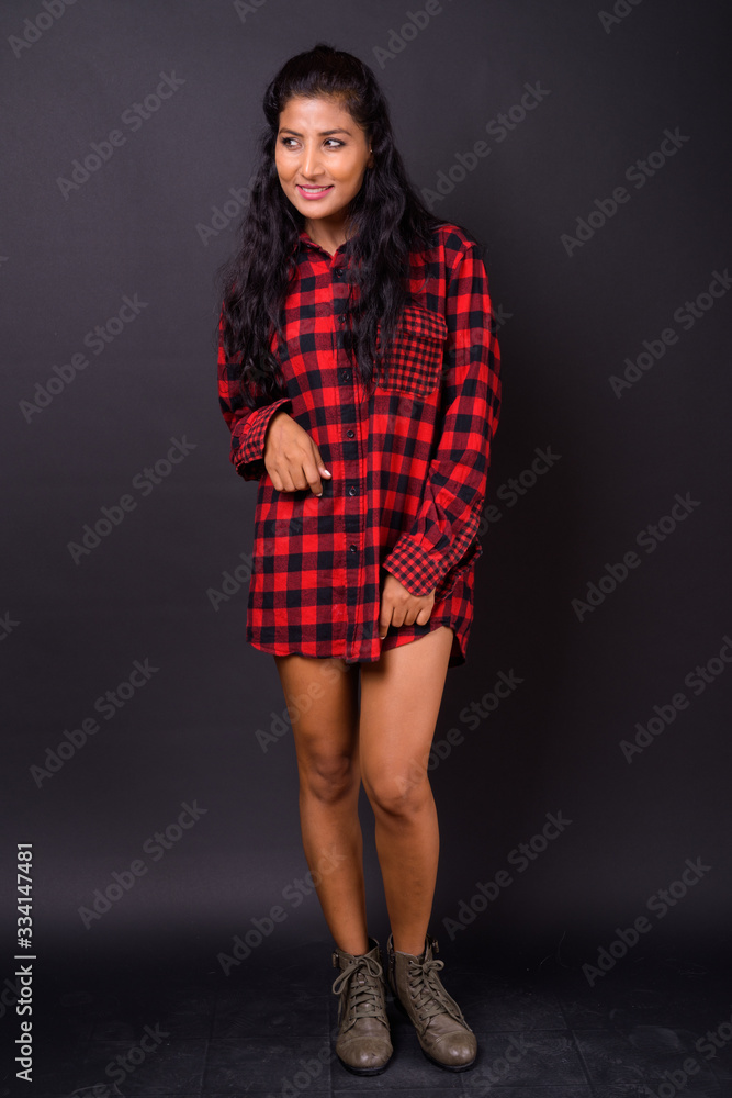 Full body shot of happy young beautiful Indian hipster woman Full body shot of happy young beautiful Indian hipster woman