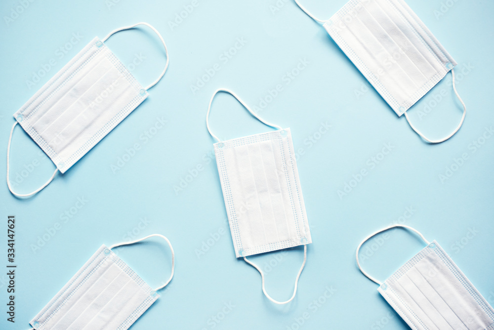 Pattern of medical masks on a blue background. Pattern of medical masks on a blue background.