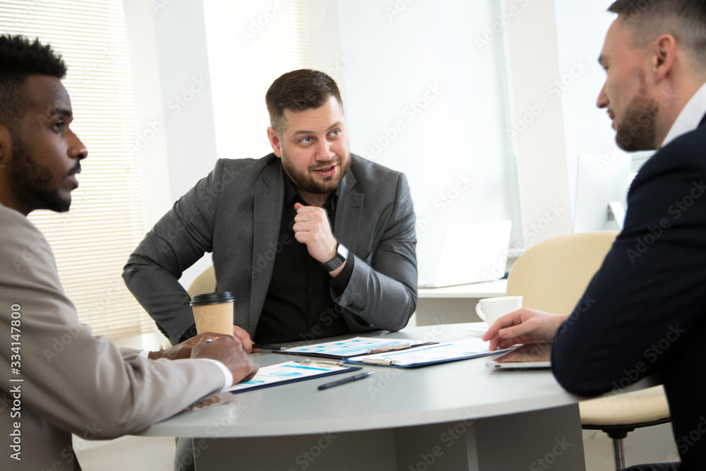 International group of business people working and communicating sitting near office desk. International group of business people working and communicating sitting near office desk.